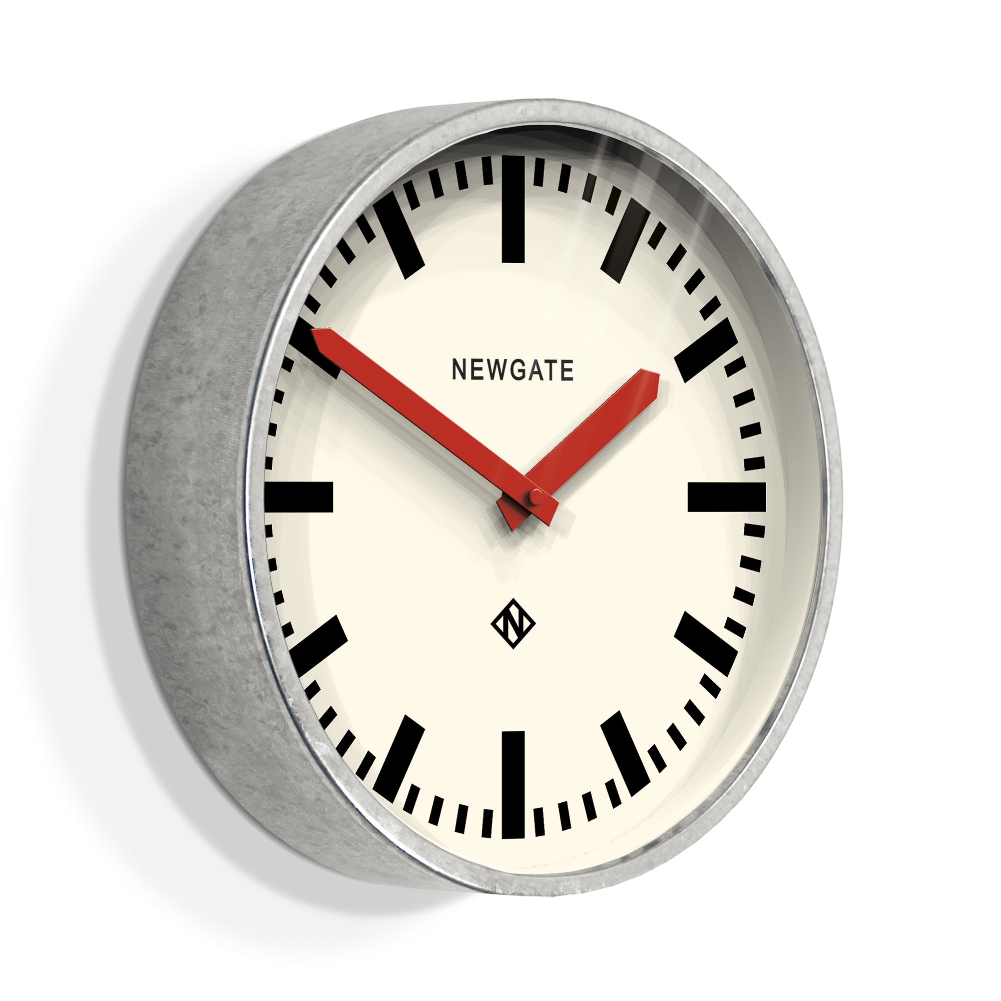 Galvanized metal wall clock with cream face, black Roman-style markers, red hands, angled view