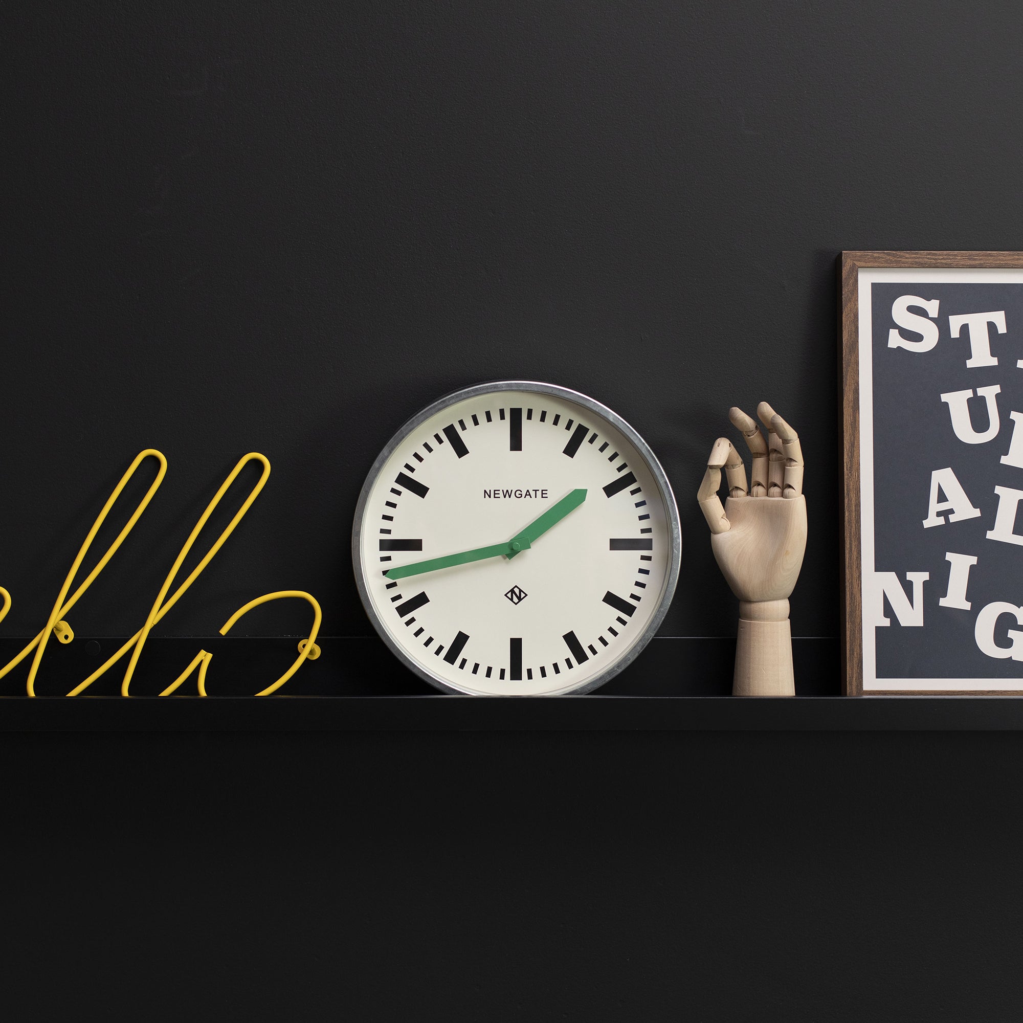 Wall clock with cream dial, black markings, green hands, and galvanised metal rim