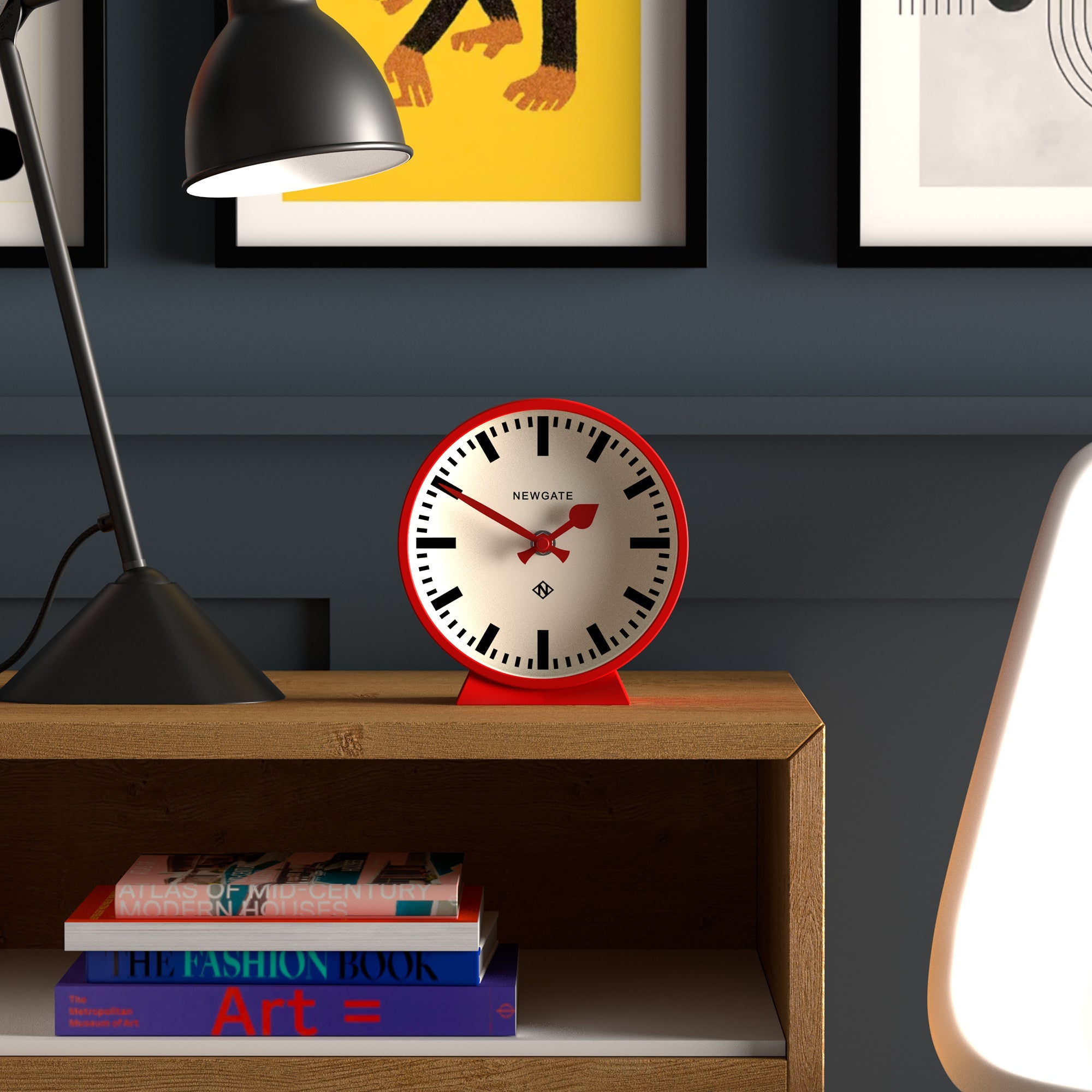 Railway mantel clock with white dial, black numerals, red hands, red base on shelf