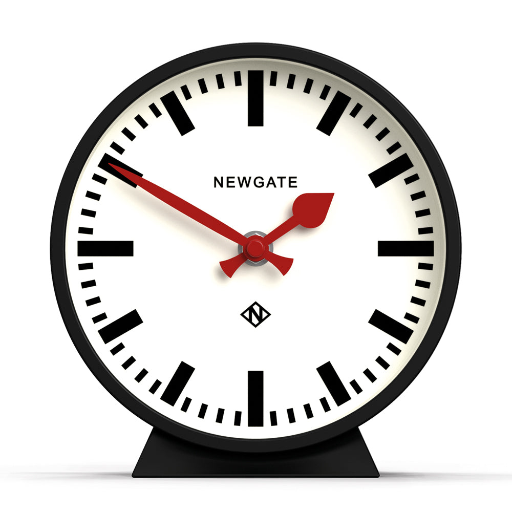 Black mantel clock with white dial, Roman numerals, and red hands