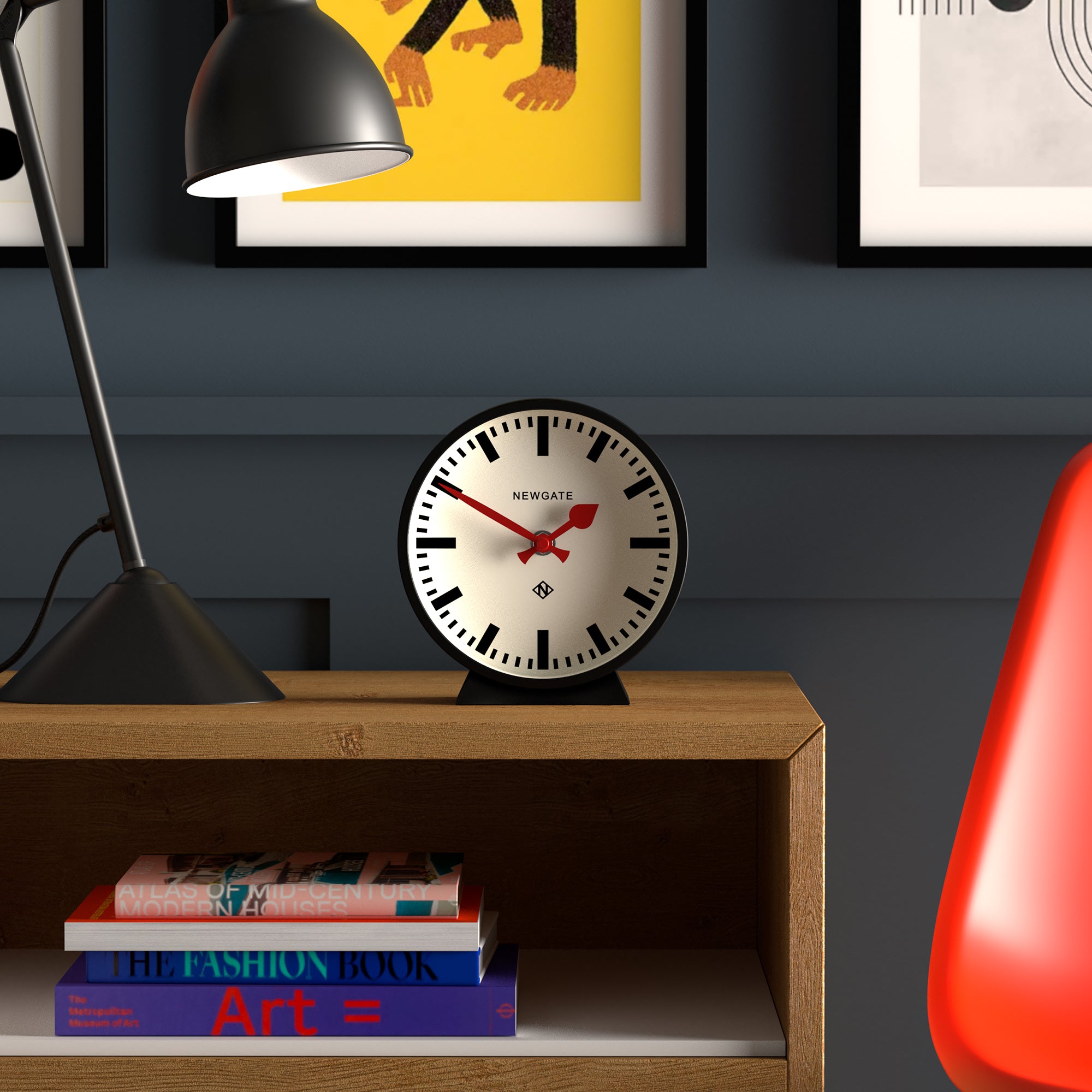 Front-view black mantel clock with white dial, Roman numerals, and red hands