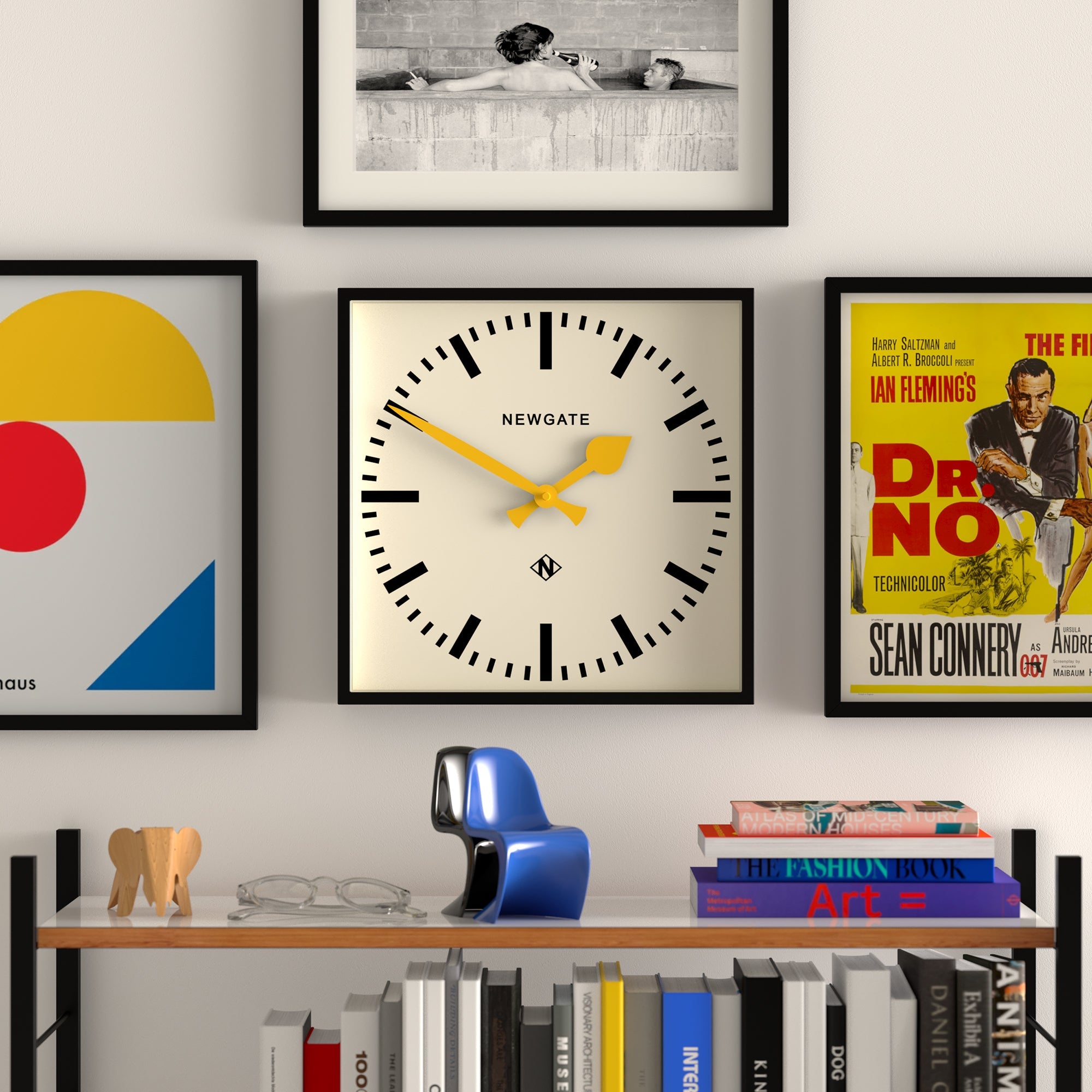 Wall clock in black frame with cream dial, yellow hands, visible Newgate logo