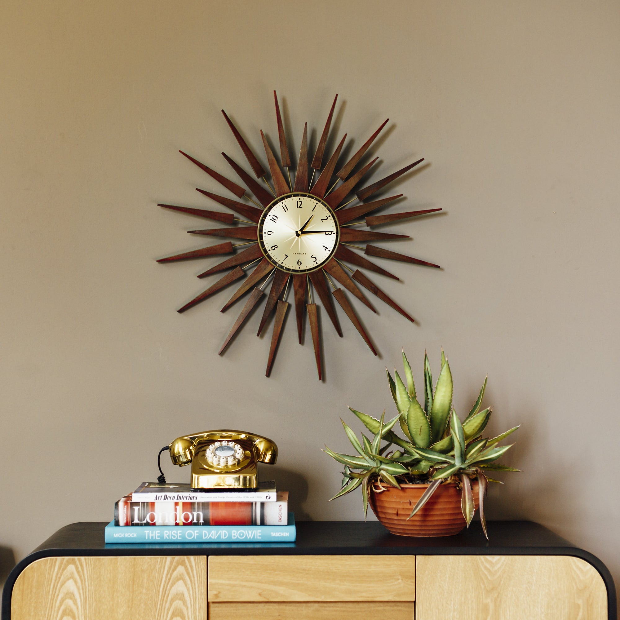 Wall clock with cream dial and dark brown radiating spiked frame