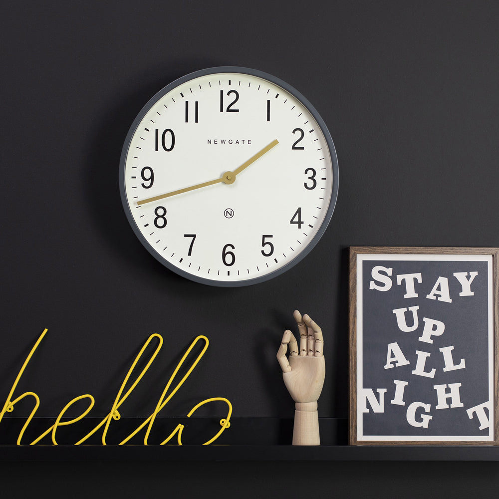 Wall clock with grey rim and cream face, gold hands, black Arabic numerals