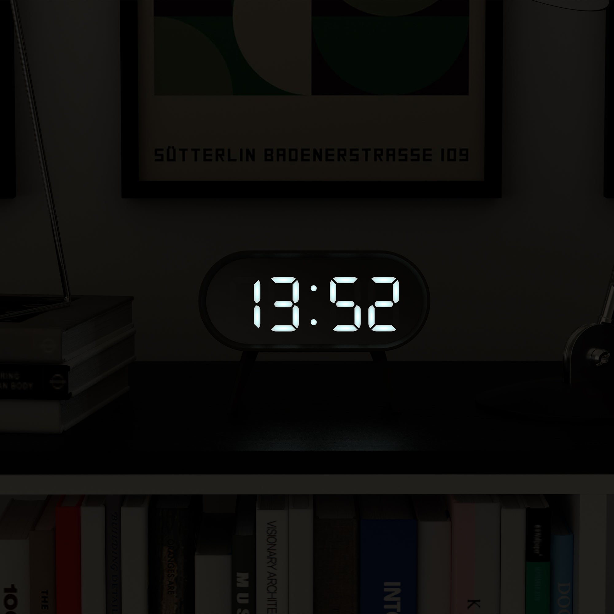 Grey LED alarm clock with illuminated digital time display 13:52, oval case