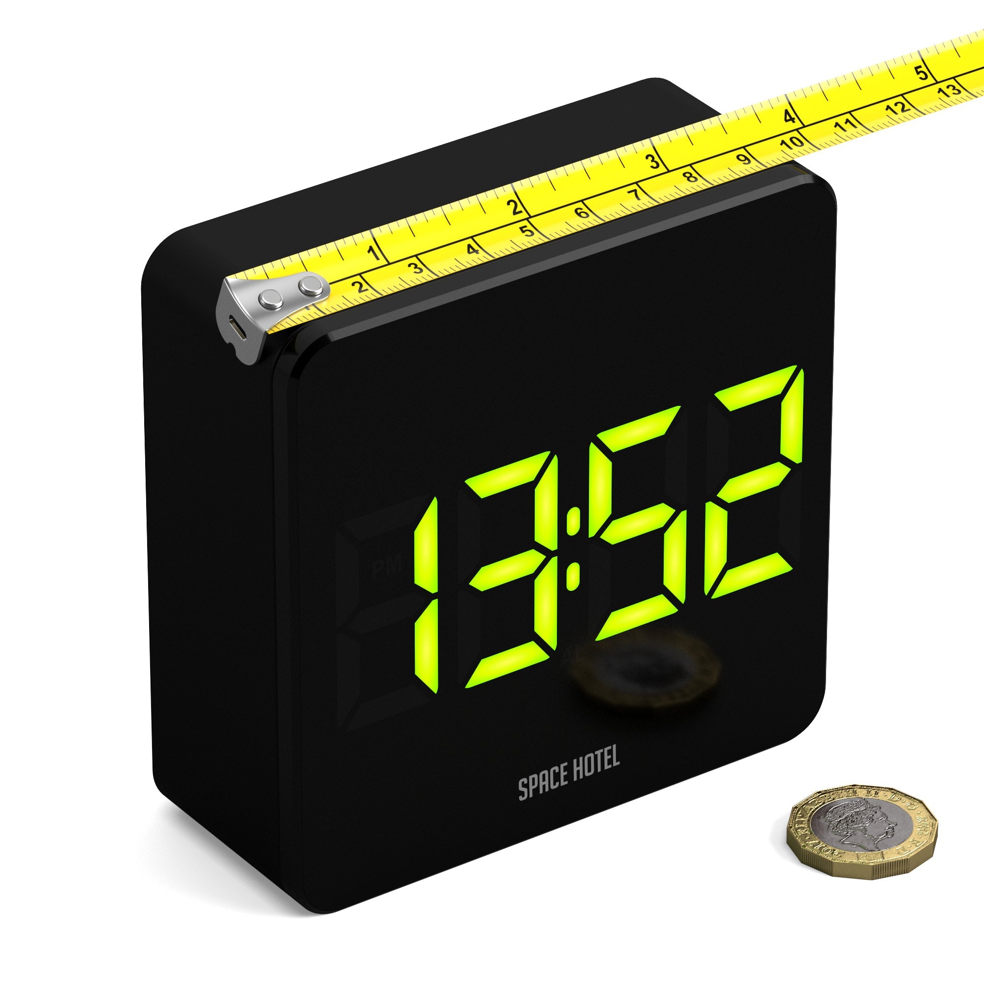 Black alarm clock with green LED digits, top ruler detail, Space Hotel logo