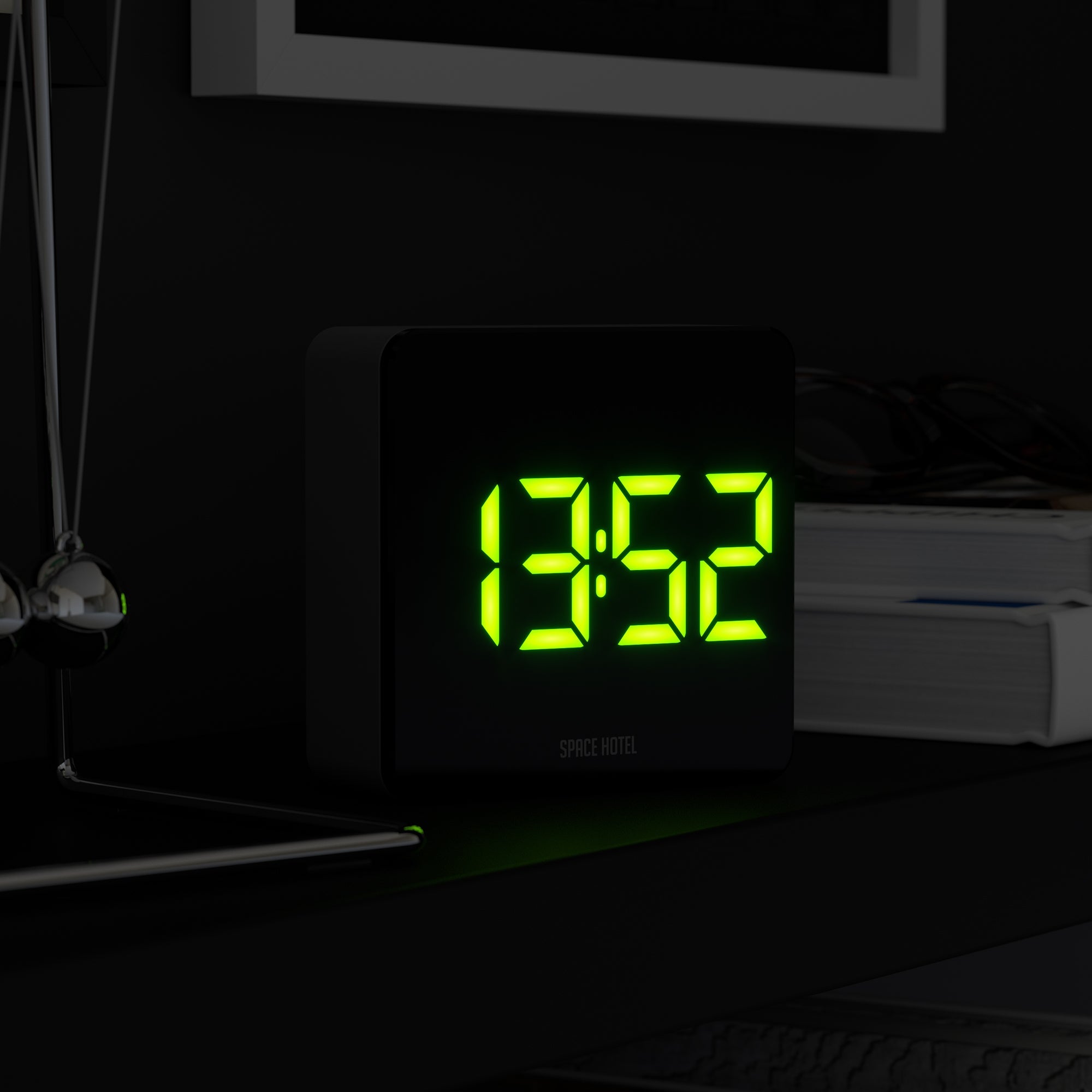 Black alarm clock with bright green LED digits on front panel