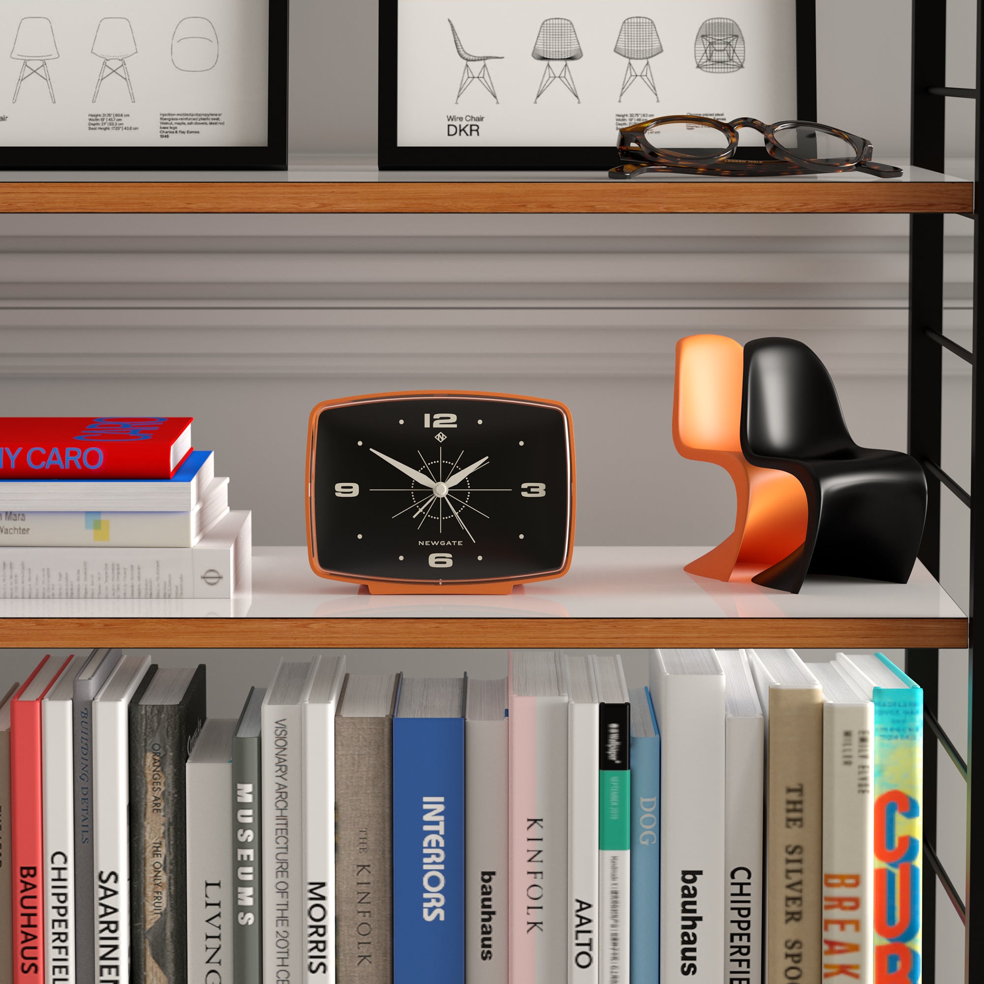 Orange alarm clock on shelf, black face with white hands and numerals