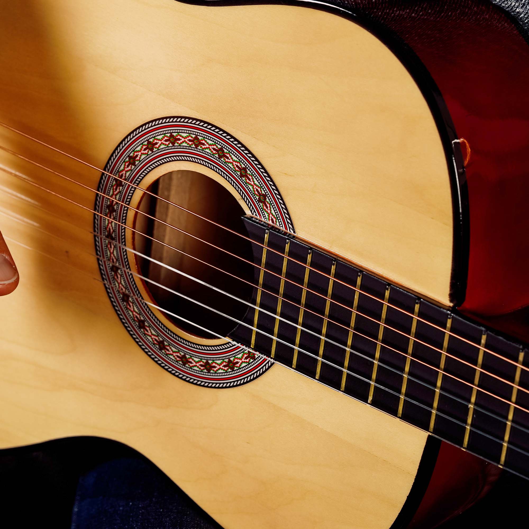 Natural classical guitar sound hole with decorative rosette and nylon strings