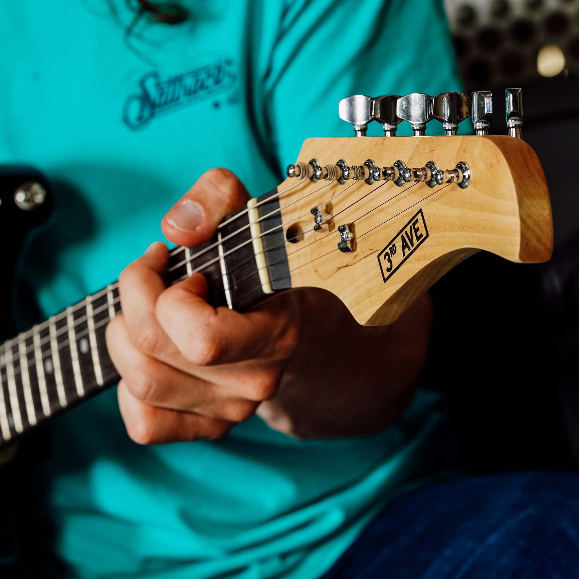 Electric guitar neck and tuning pegs in close-up