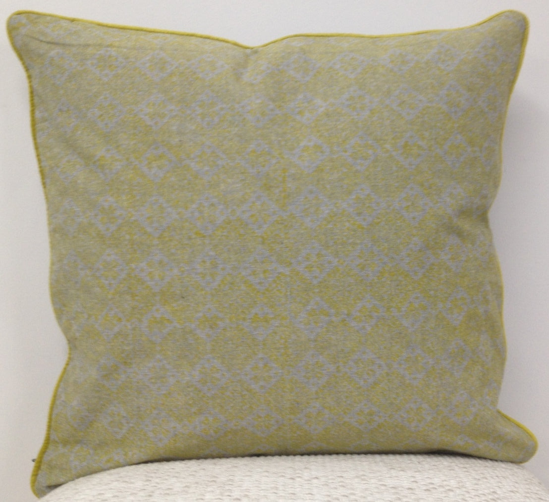 Mustard yellow cushion cover with geometric pattern and stitched border