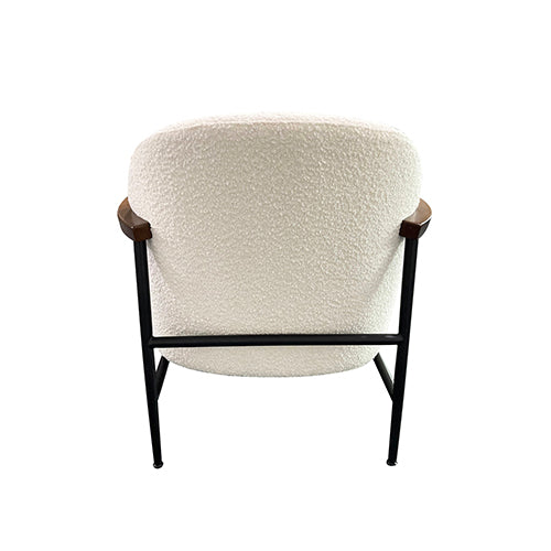 Rear view of upholstered armchair with cream polyester upholstery and black metal legs