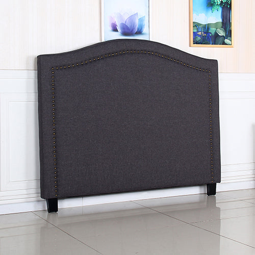 Charcoal upholstered queen headboard with arched top and evenly spaced nailhead trim