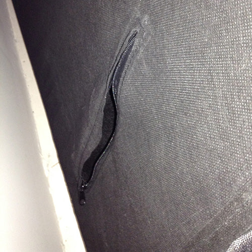 Upholstery side seam detail with black piping on dark charcoal linen fabric