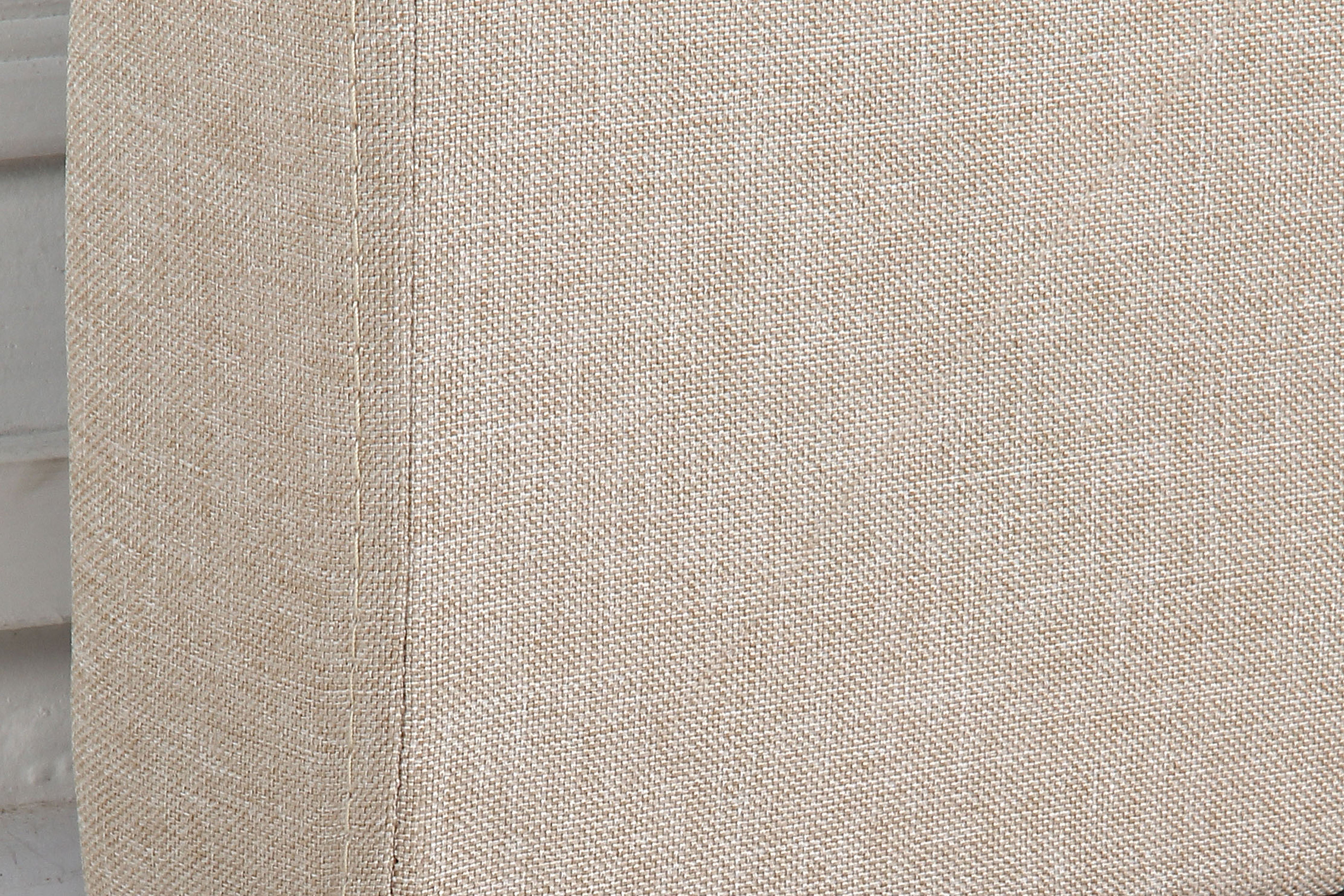 Beige upholstered headboard fabric panel with textured weave and stitching