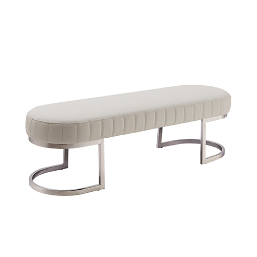 Padded bench chair with light beige tufted upholstery and polished stainless steel curved legs