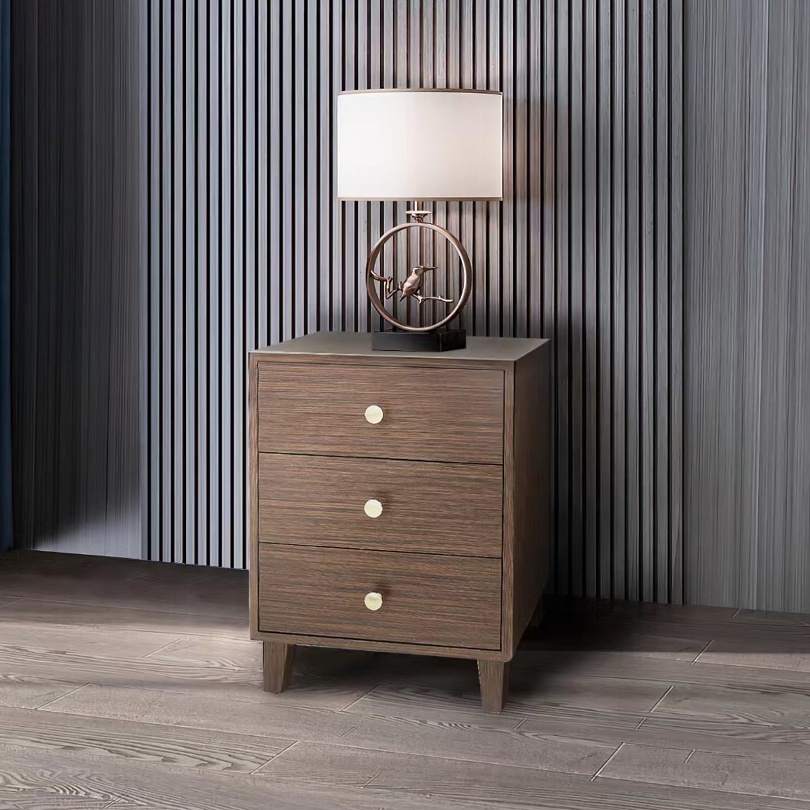 Brown bedside table with three drawers and round brass knobs, on tapered feet.