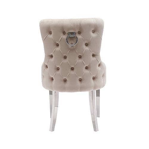 Beige velvet dining chair with button-tufted back, ring handle, and stainless legs