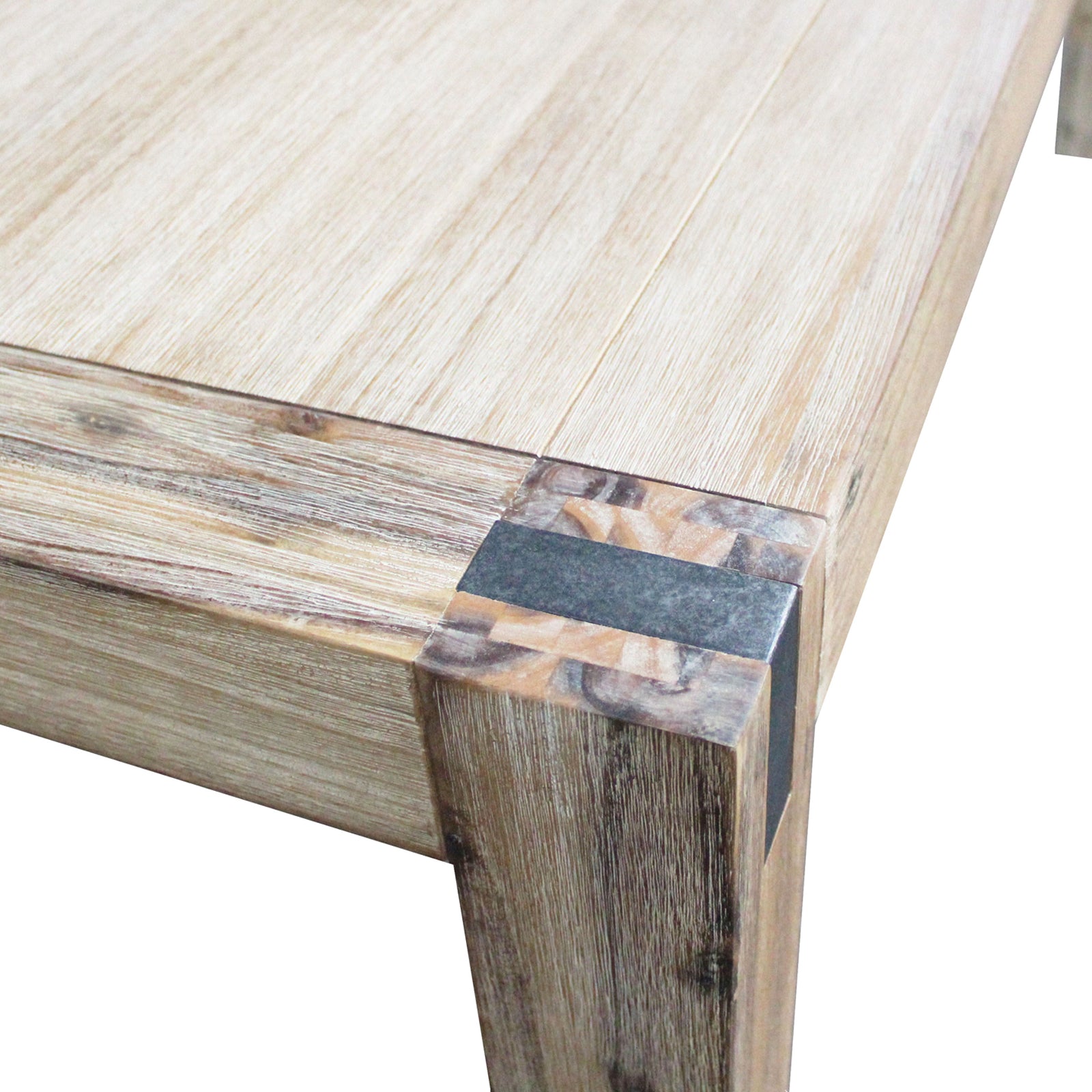 Close-up of oak acacia table edge and corner join between tabletop and leg.