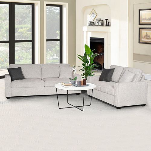 L-shaped sofa set with light gray upholstery and dark accent pillows
