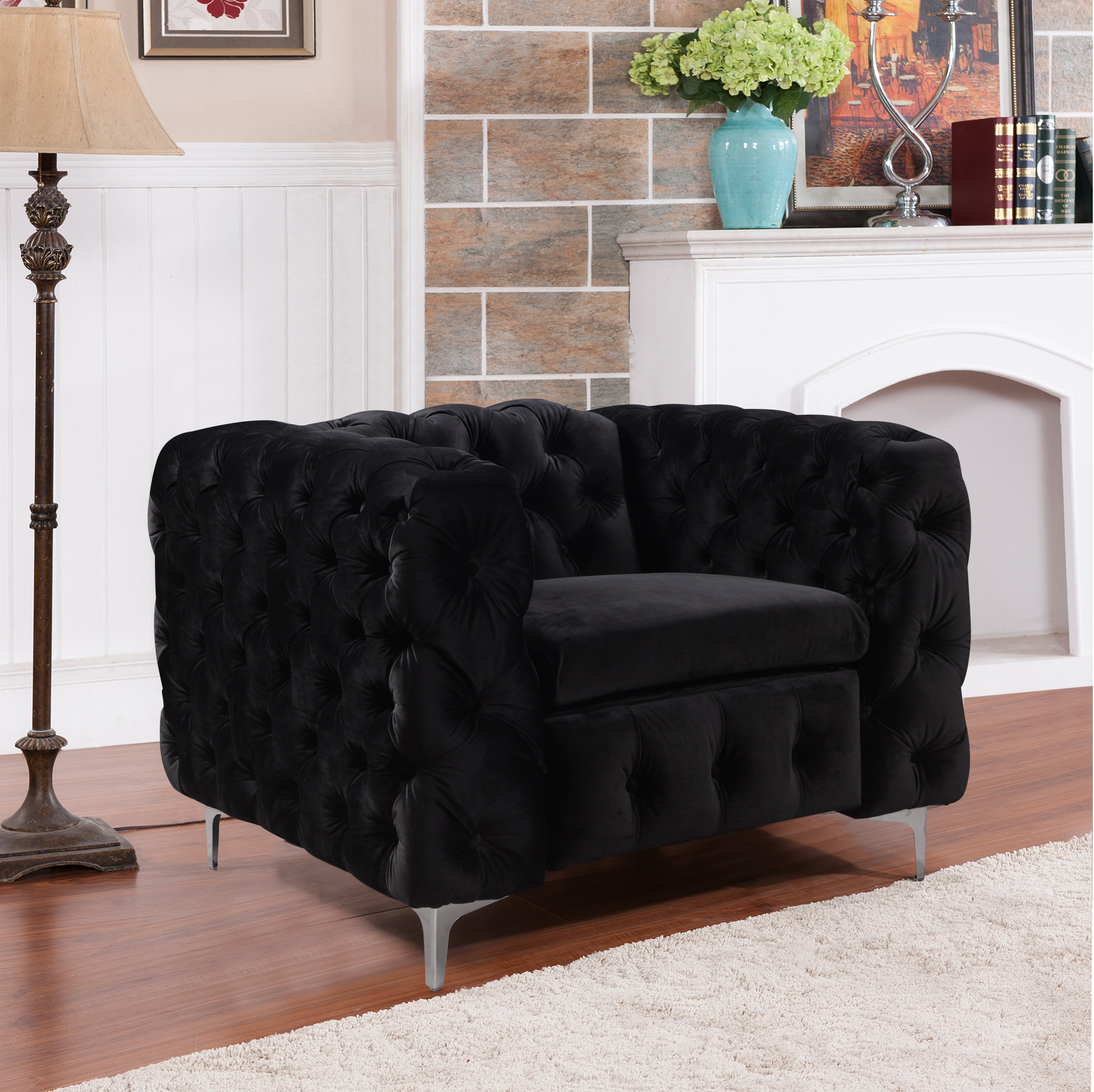 Black velvet tufted armchair with buttoned back and arms, metal legs