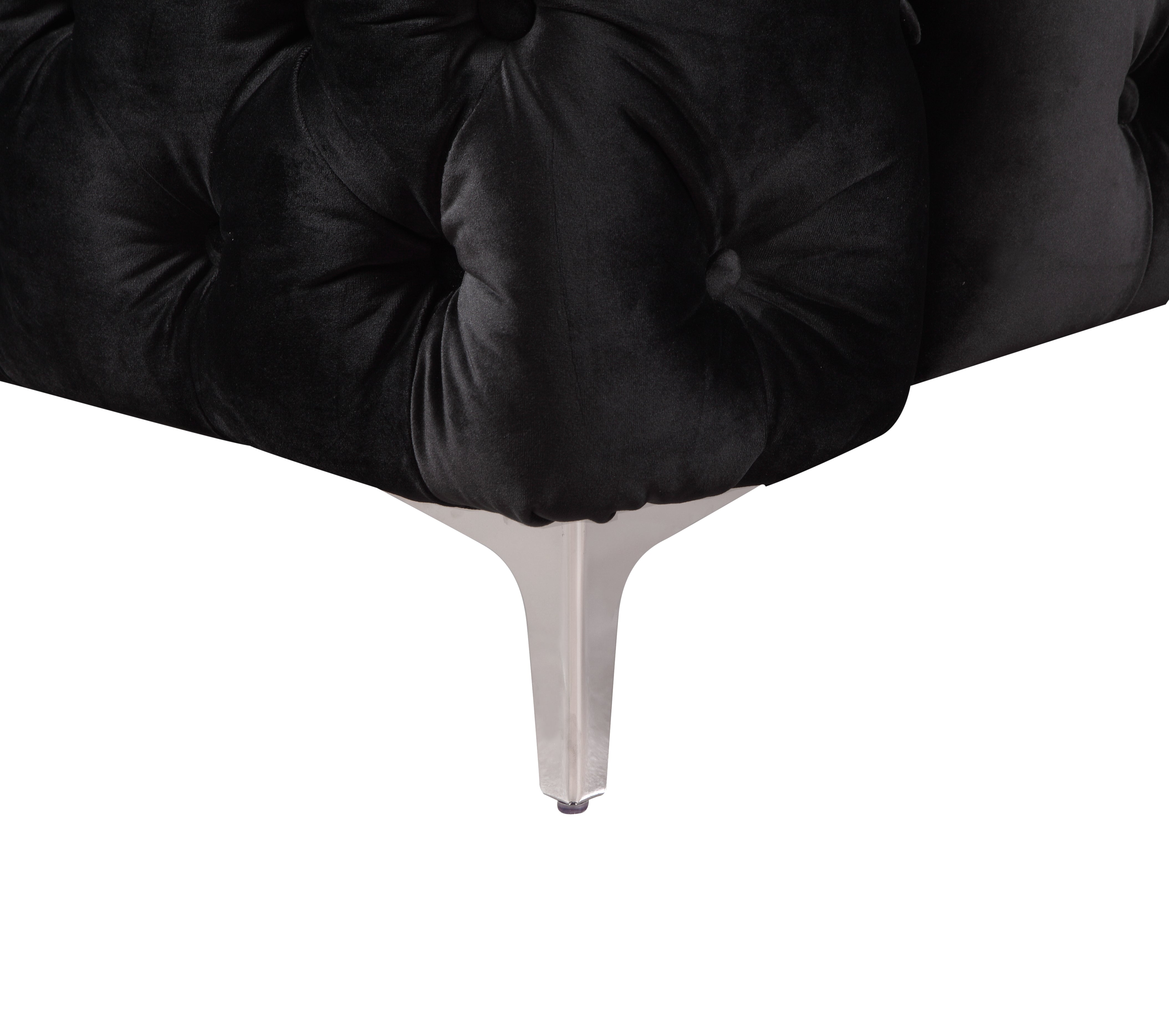 Black velvet tufted armchair with metal legs, rounded corner view