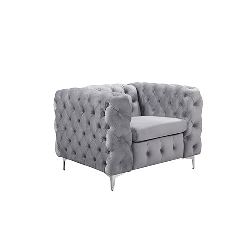 Grey velvet button-tufted armchair with padded arms and metal legs
