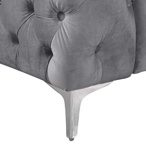 Grey velvet armchair with tufted base and metal legs with small feet