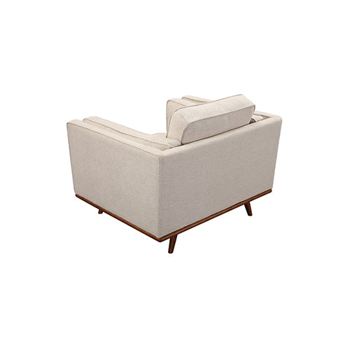 Beige fabric armchair with high back, stacked cushions, and wooden legs