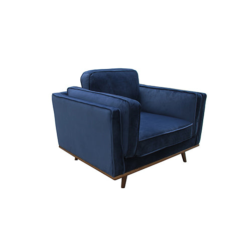 Modern single-seater armchair with dark blue velvet upholstery and wooden legs