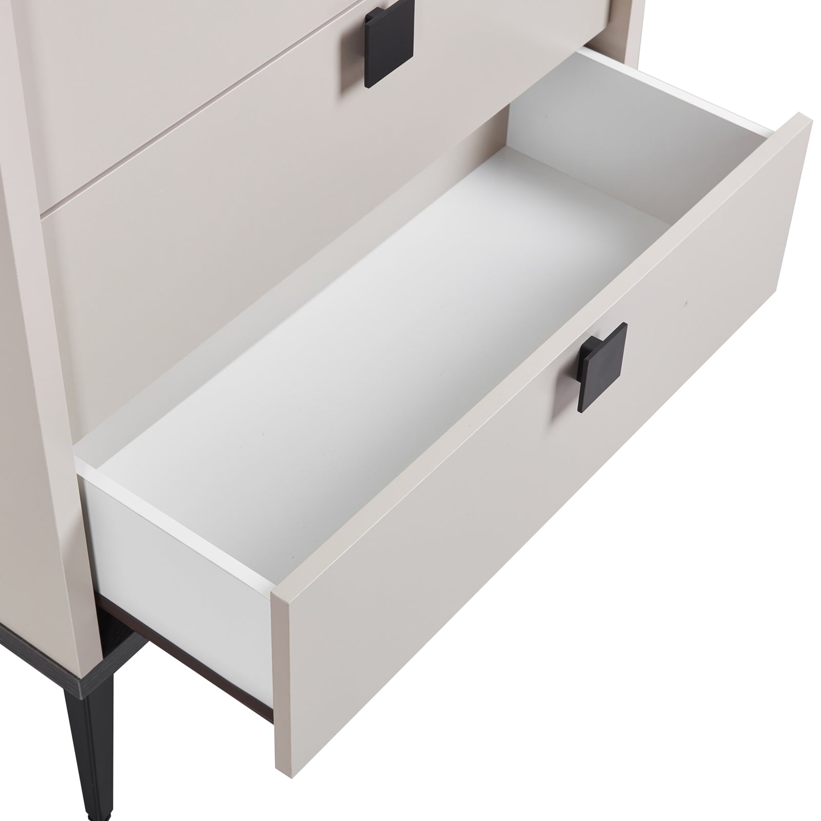 Tallboy cabinet open drawer, showing empty light interior and black handle