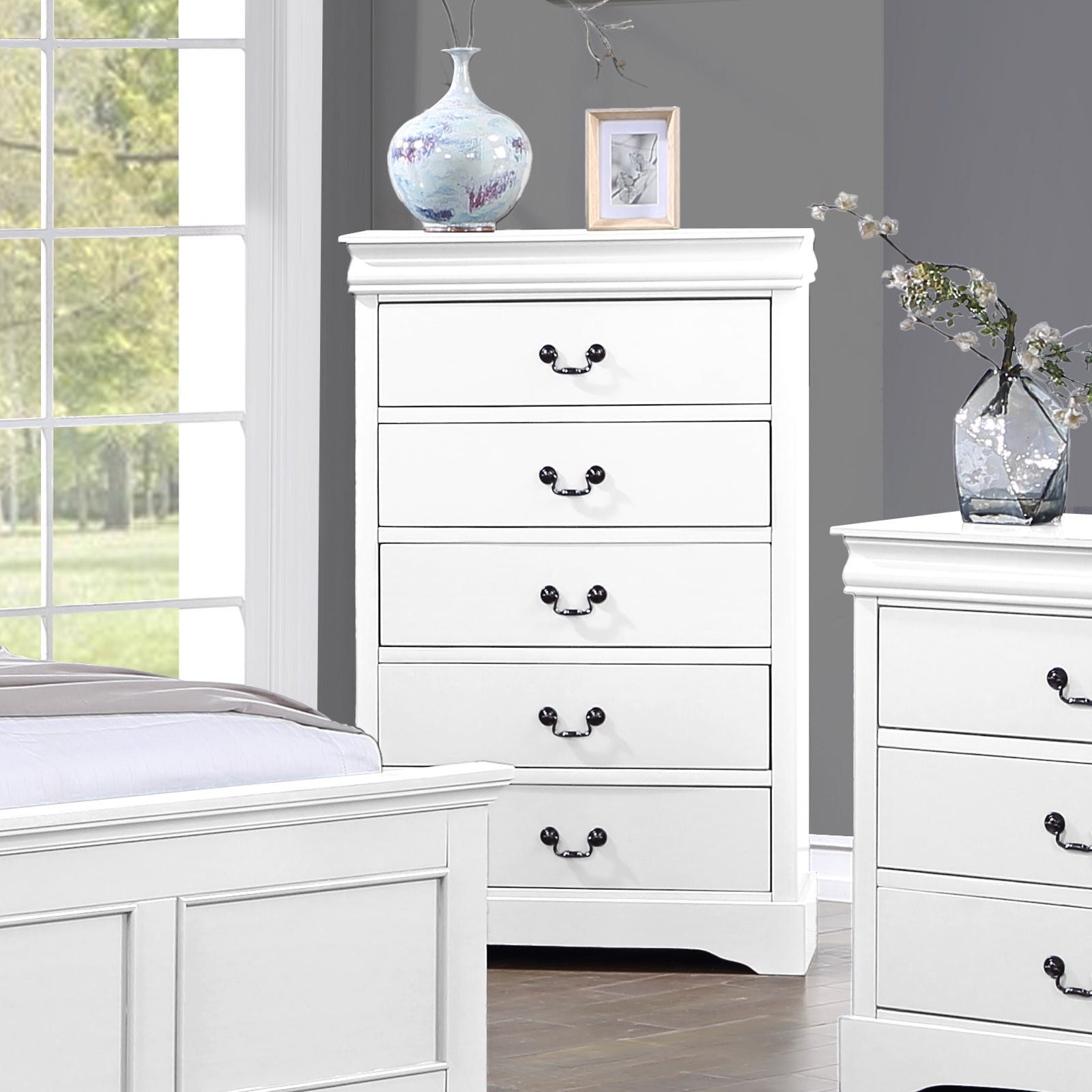 White tallboy dresser with five drawers and black metal handles