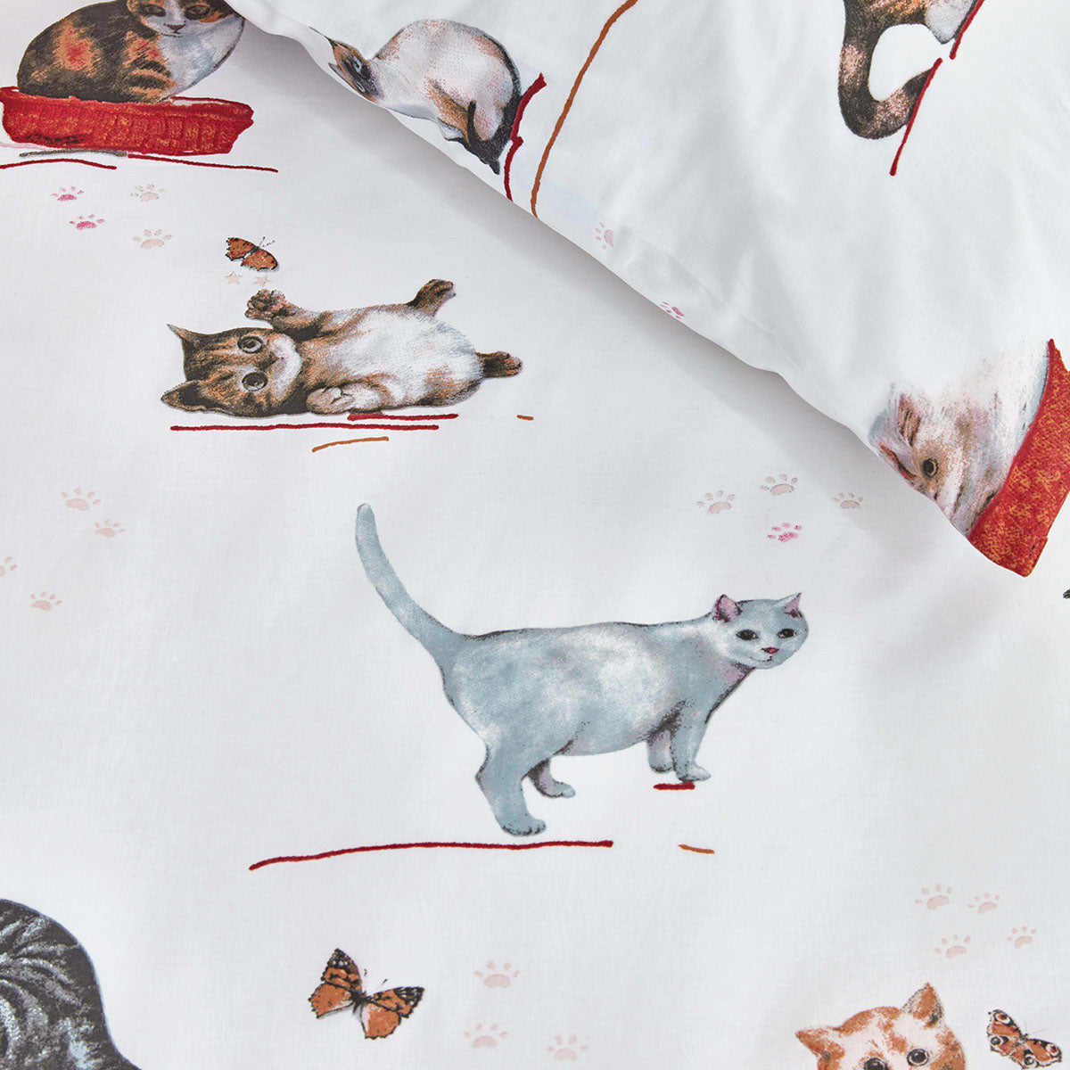 Cotton quilt cover fabric with illustrated cats, paw prints, and red brush strokes on white