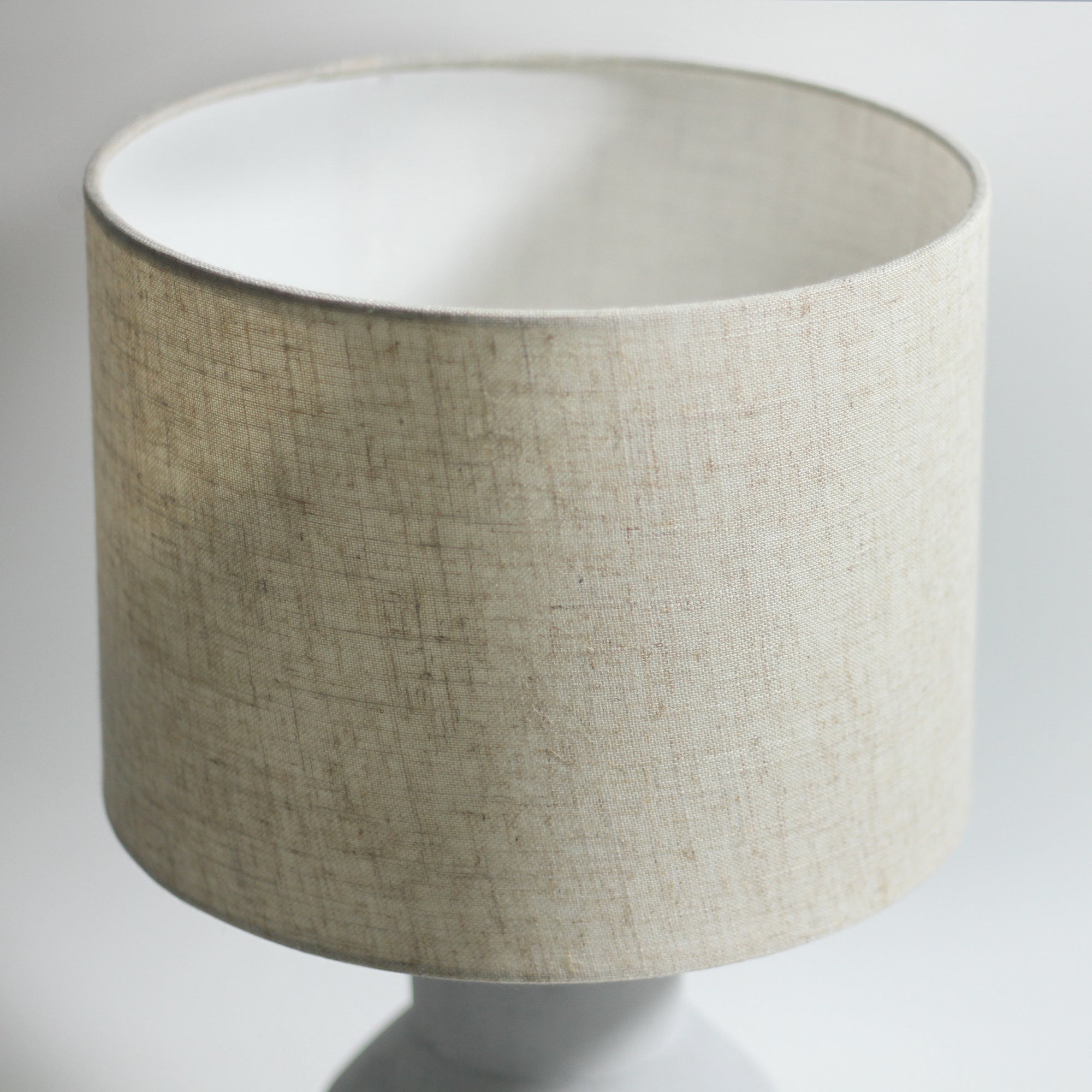Beige fabric drum lamp shade with white inner lining