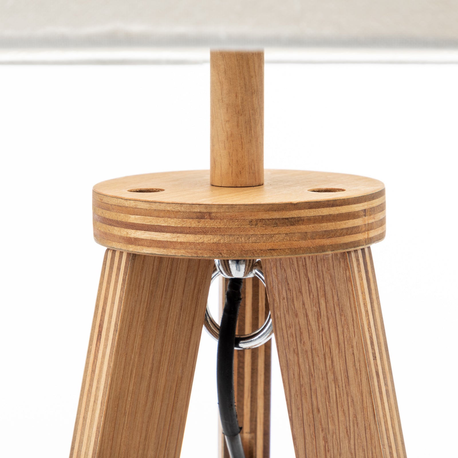 Wooden lamp base with metal socket and center support on tripod legs