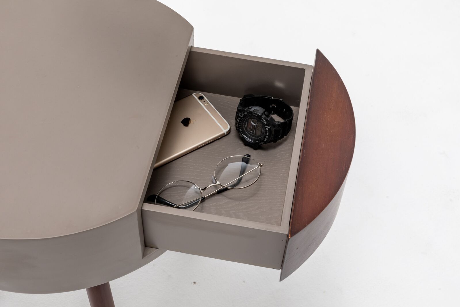 Lamp drawer open showing phone, watch, and small accessories