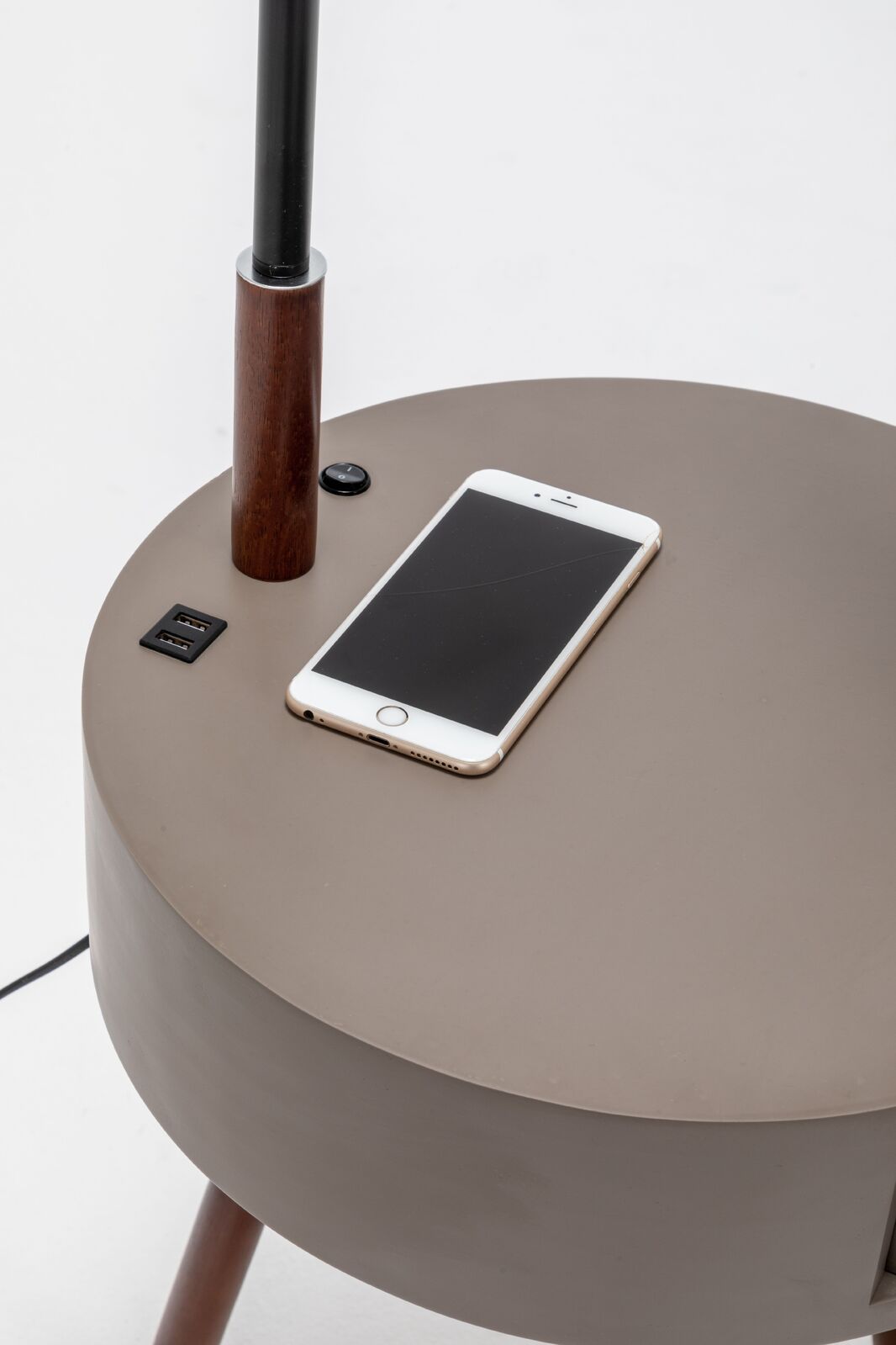 Round side table lamp with USB port and smartphone resting on tabletop