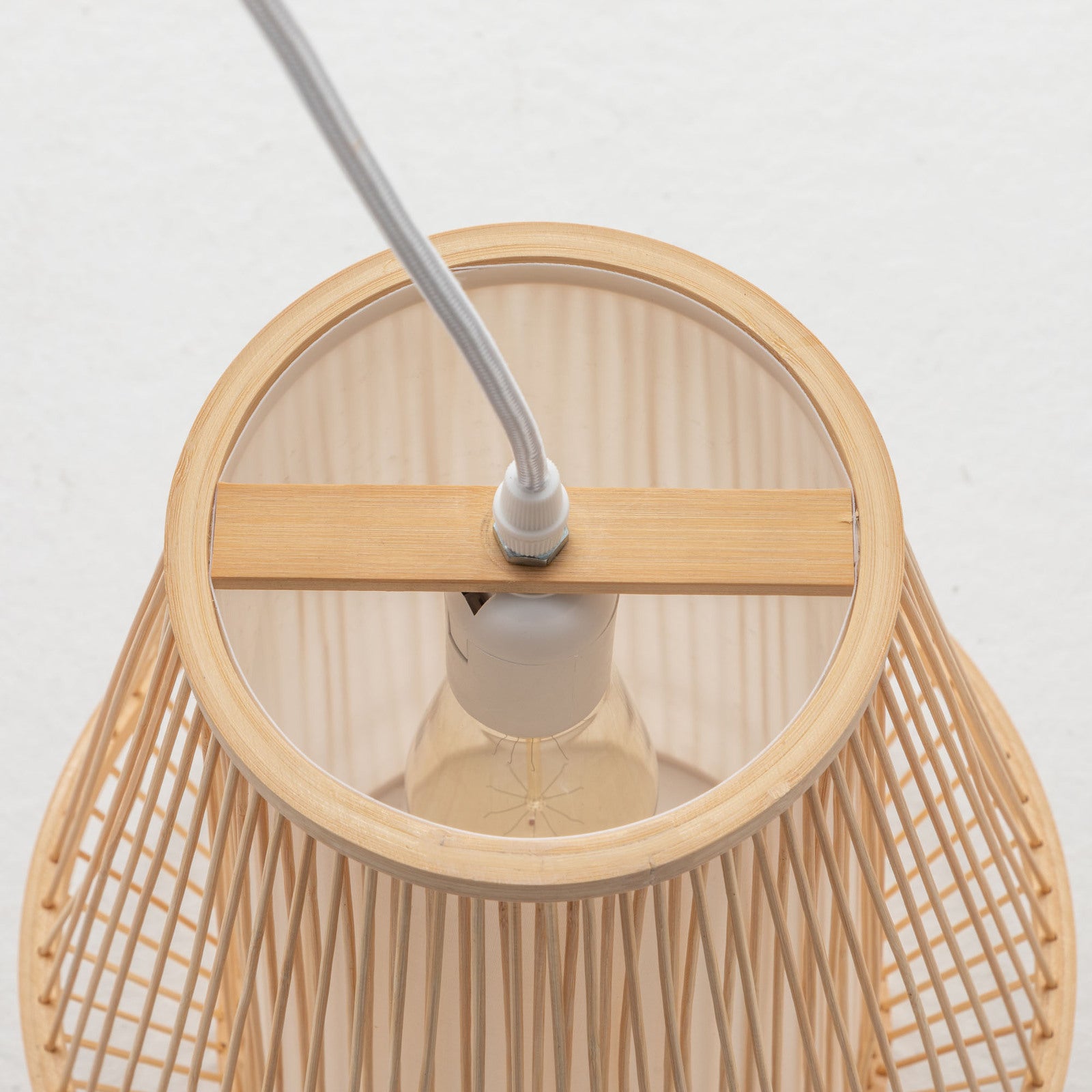Natural bamboo woven lamp shade interior with visible bulb socket