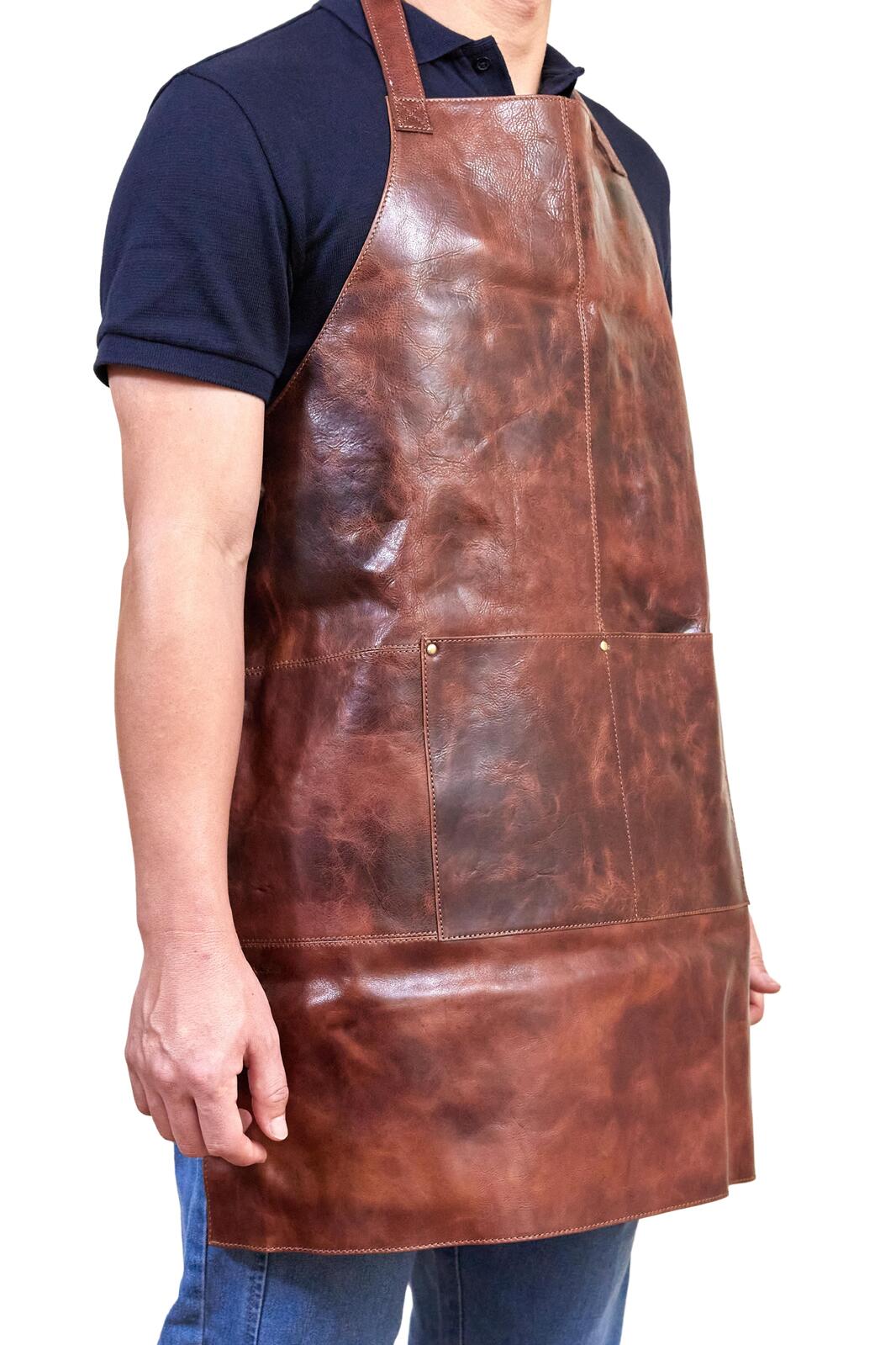 Cognac leather apron with side seam, wide straps, and straight hem