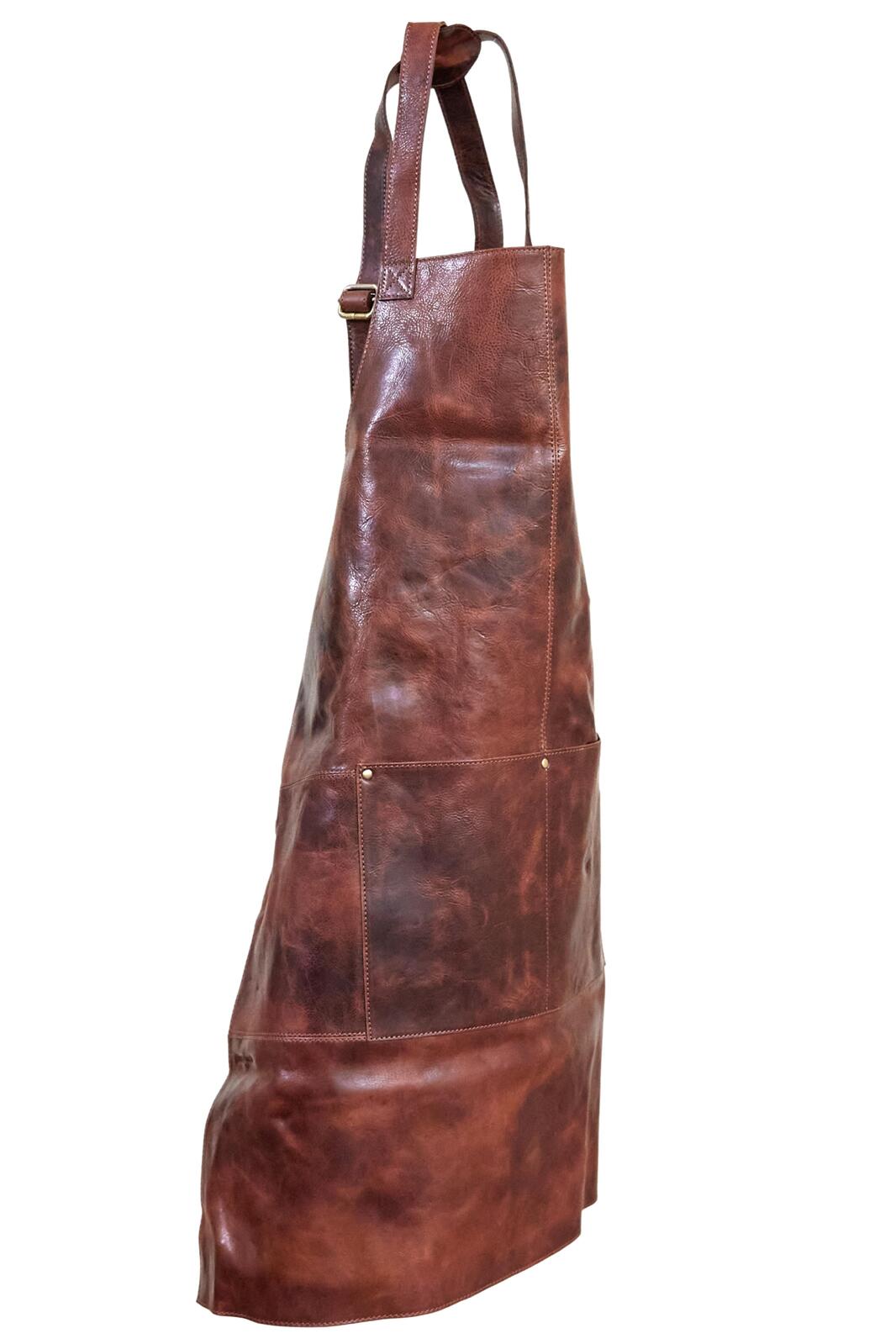Cognac leather apron standing upright with front pocket and wide waist panel