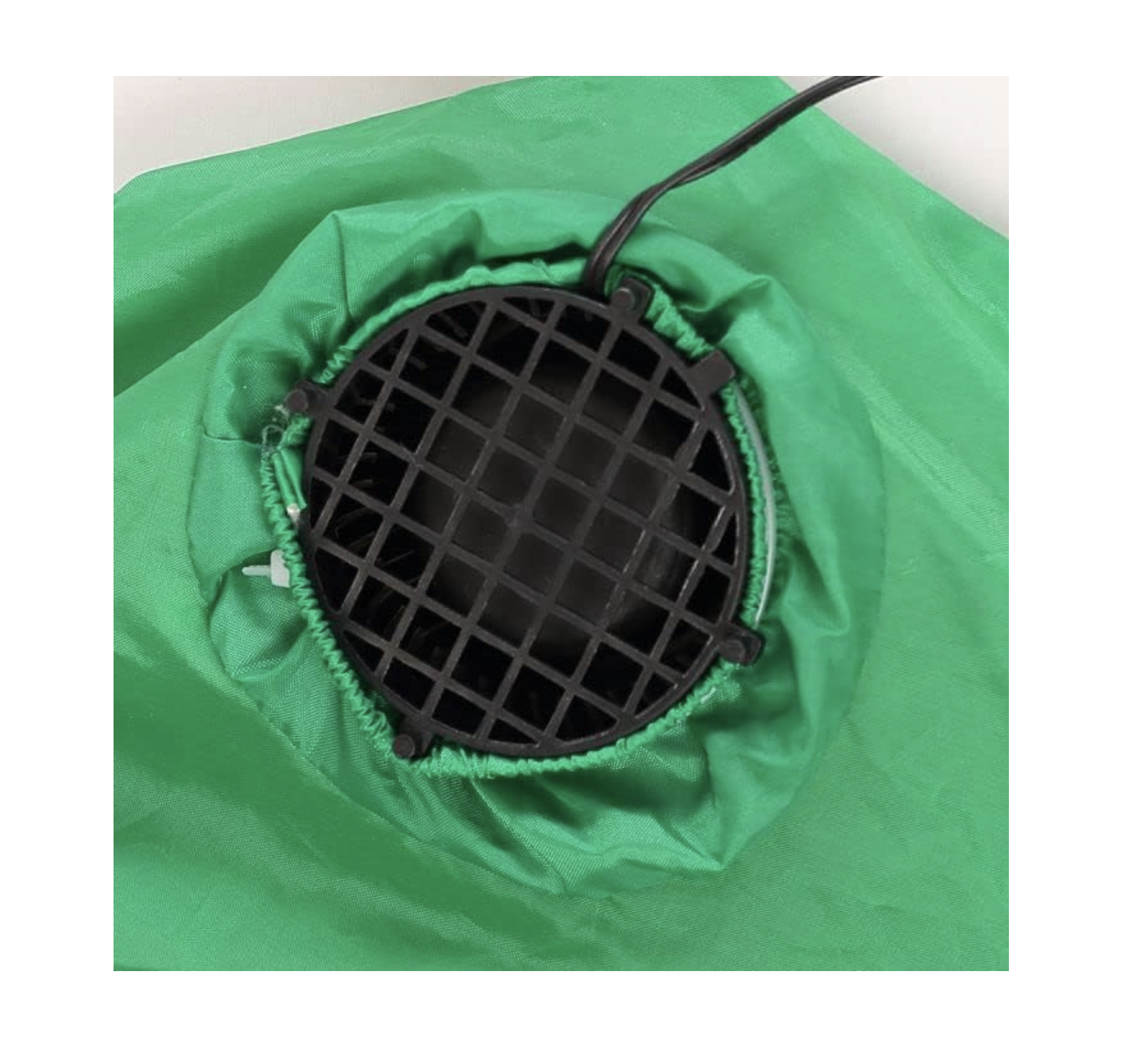 Inflatable fan intake opening with black mesh cover on green fabric