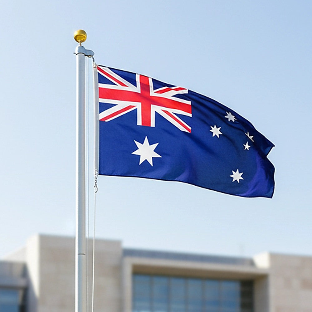 Australian flag on flagpole with golden top finial, blue fabric with white stars