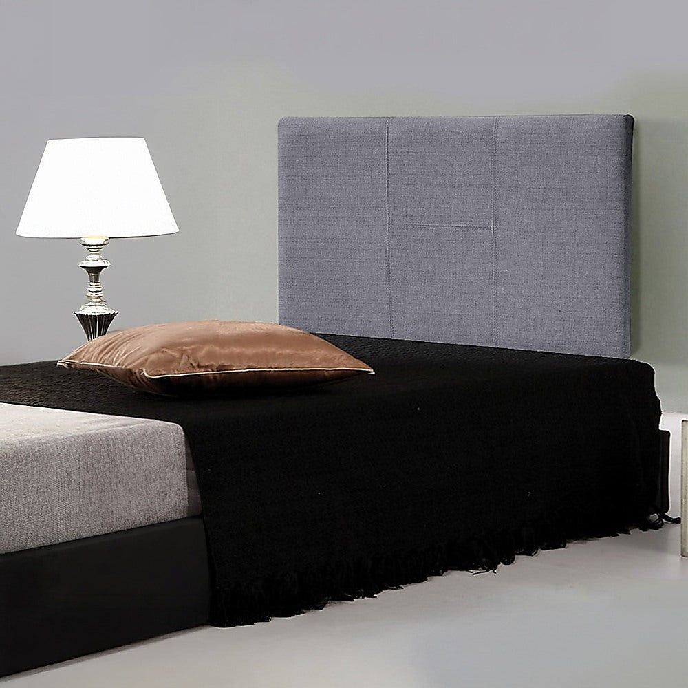 Grey linen headboard with padded panels and black legs, shown with bed