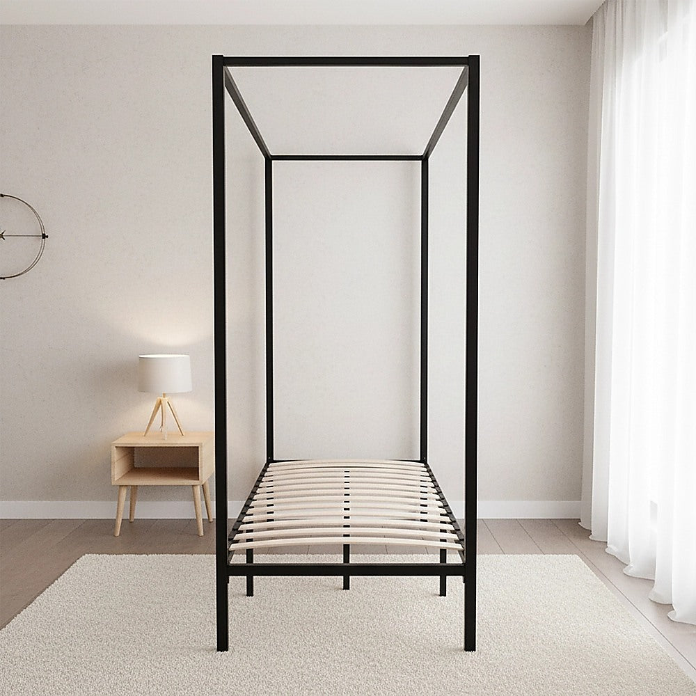 Black four-poster single bed frame with slatted base and open head-to-foot frame.