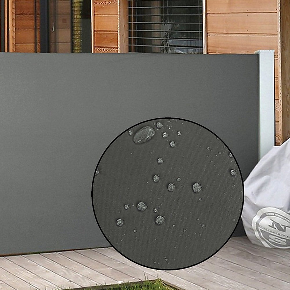 Retractable side awning shade fabric with visible water droplets on dark gray panel