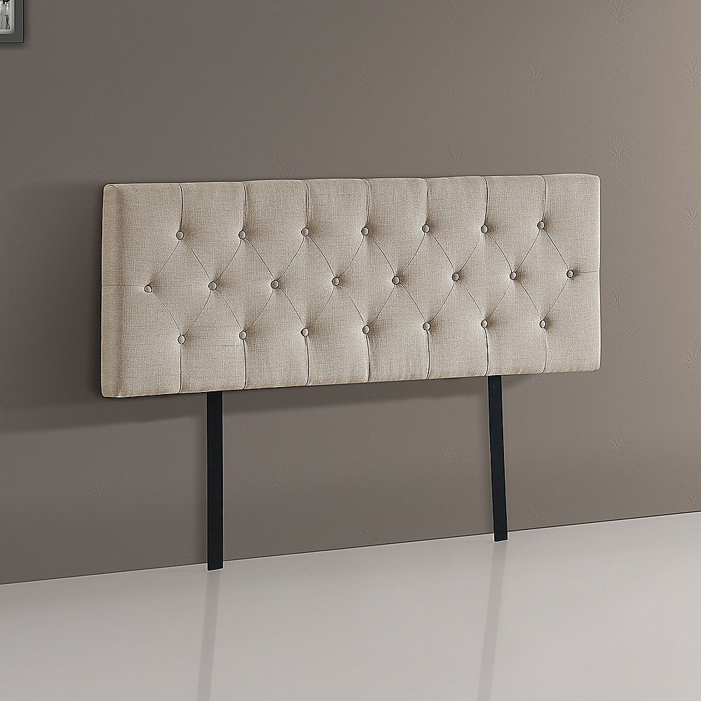 Beige linen queen headboard with button-tufted diamond pattern mounted on two legs