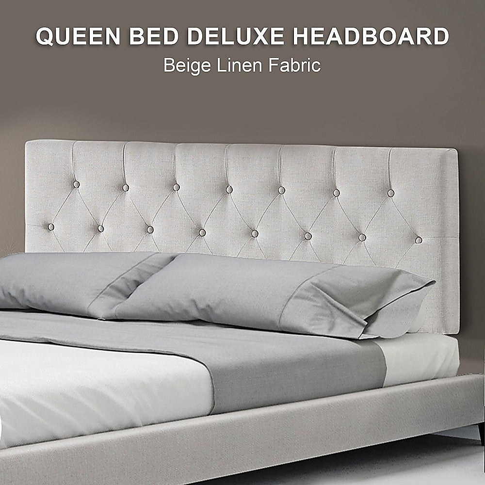 Beige linen queen headboard with button-tufted diamond pattern above neatly styled bedding