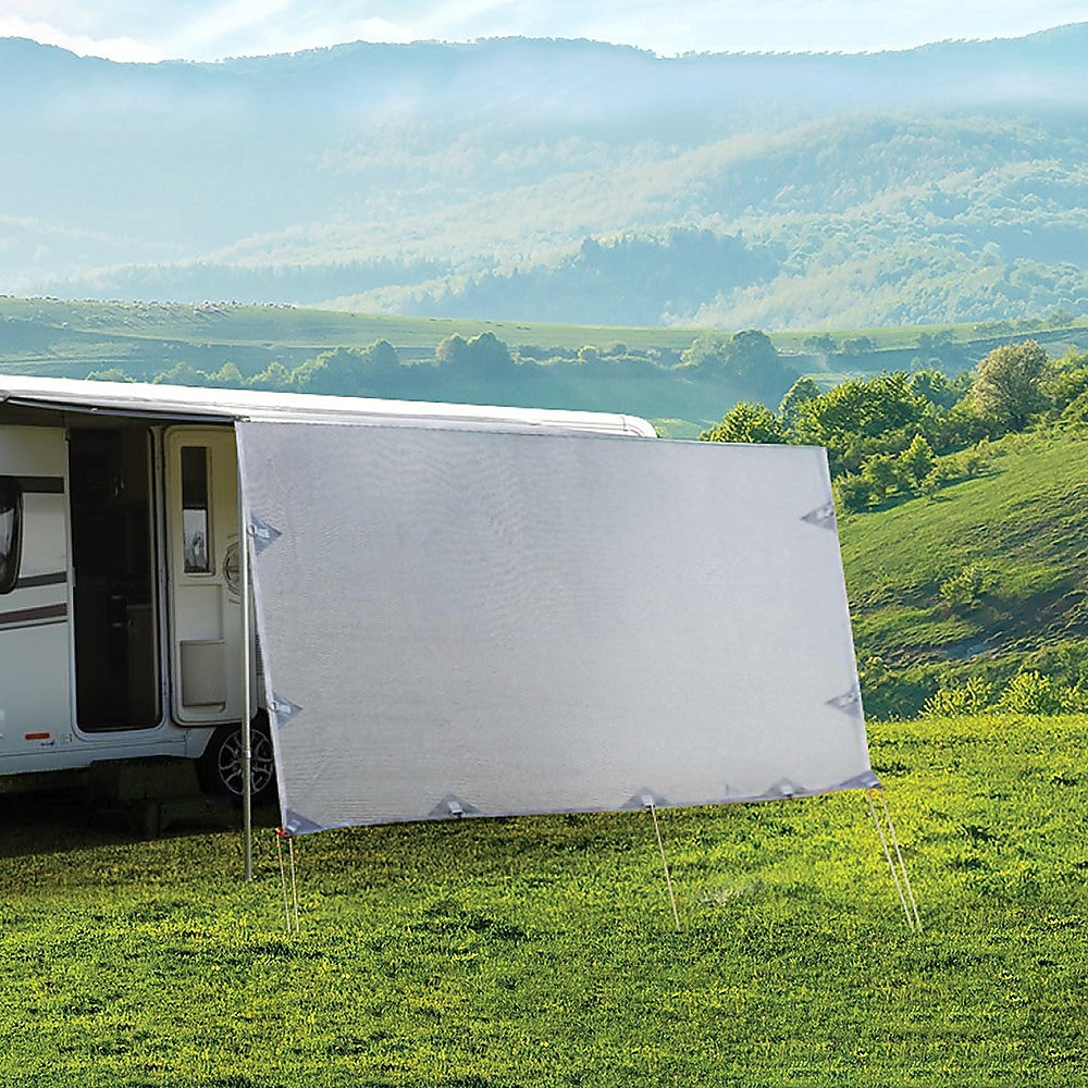 Caravan side sun shade privacy screen with gray fabric, staked to the ground