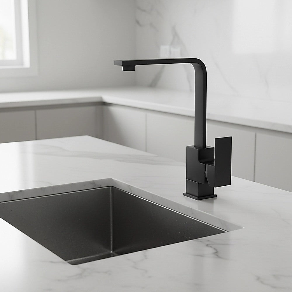 Matte black mixer tap faucet mounted over a corner square sink