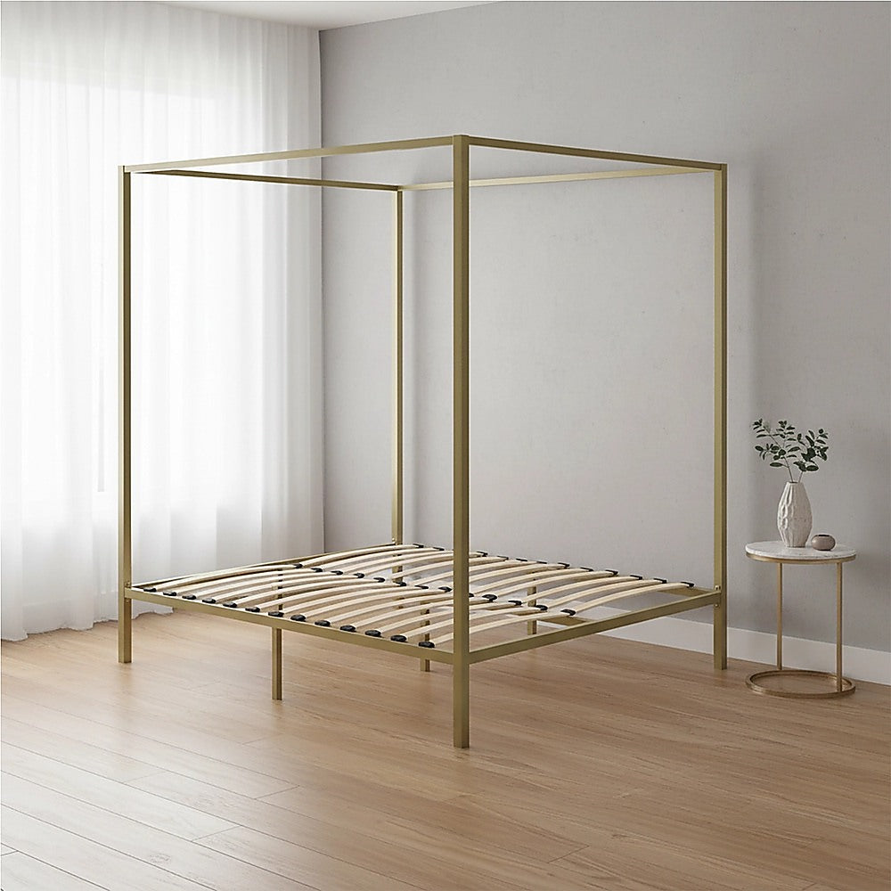 Four-poster double bed frame with gold metal posts and slatted mattress base